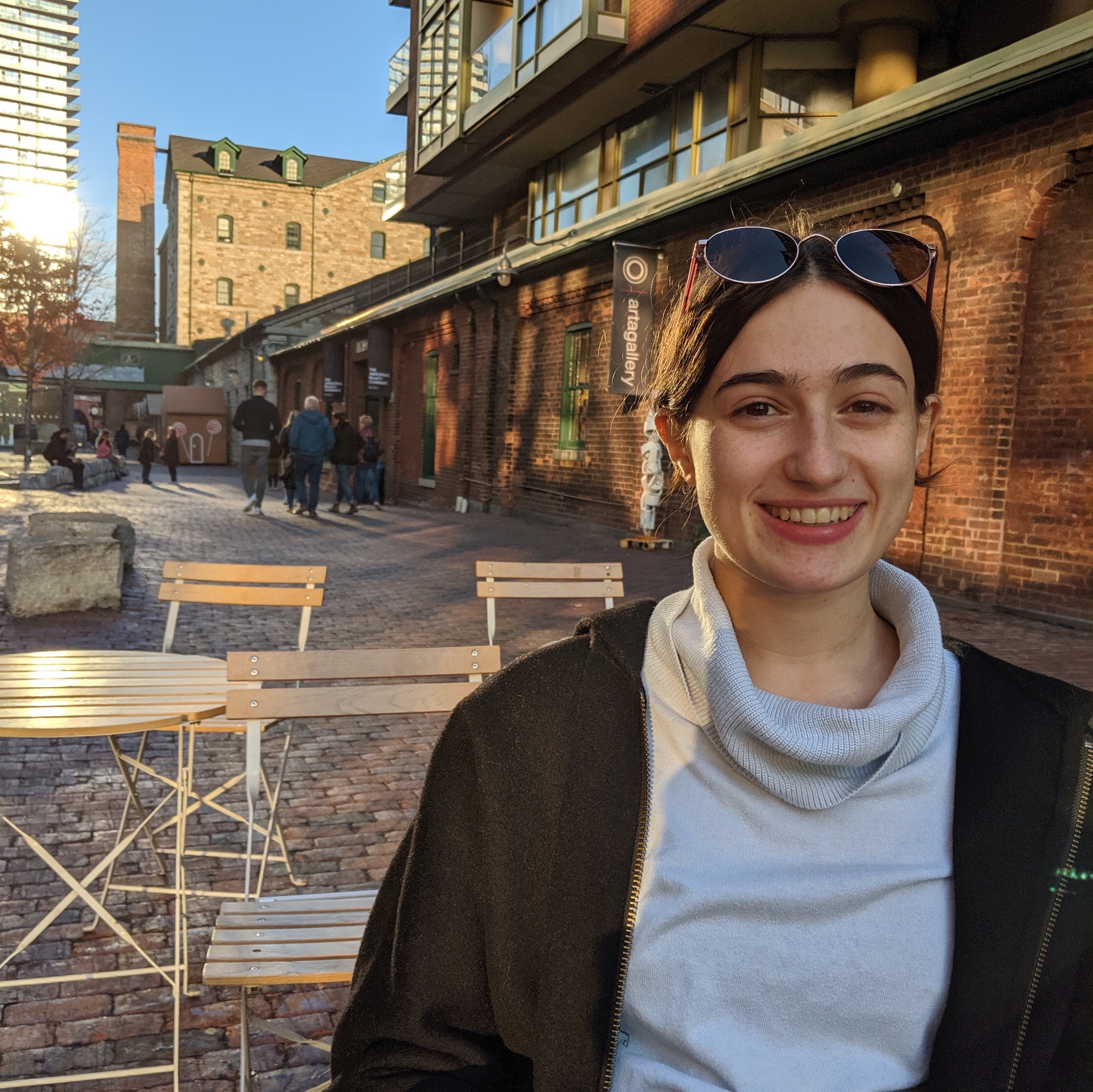 Bailey smiling and sitting in the Distillery District. 