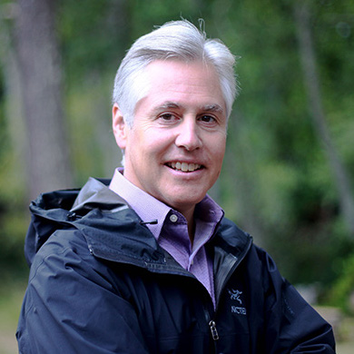 John Borrows smiling in front of trees.