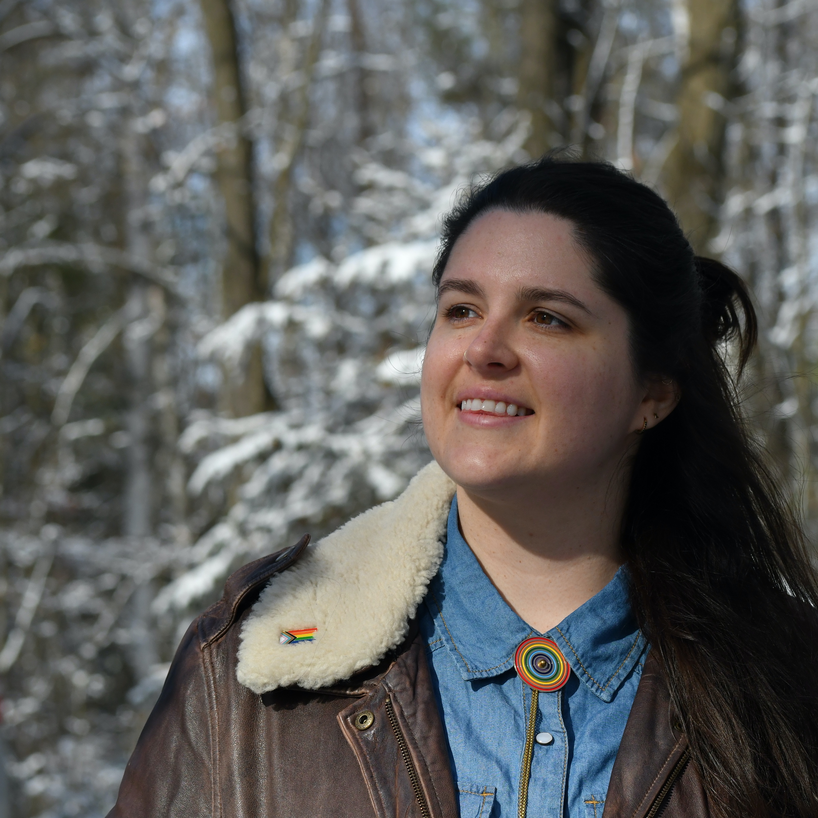Lauren smiling in front of snowy trees. 