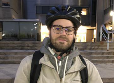 Mischa Young on campus wearing a bike helmet