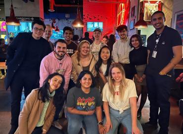 12 undergraduate students posing for photo in pub