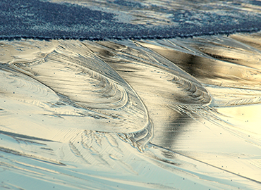 picture of swirled frost on a frozen lake