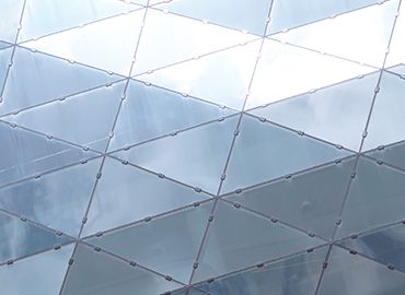 close up of a building facade made of steel triangles
