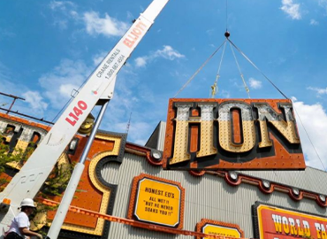 a screenshot from the honest eds documentary showing a crane taking down store sign