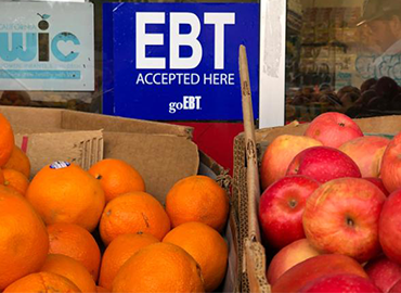 a box of apples and oranges for sale